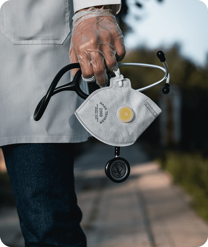Doctor holding a stethoscope and a face mask Doctor holding a stethoscope and a face mask